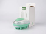 A mint green and clear silicone hair brush with green bristles, shown in front of its white packaging box with a green 'hilstar' label, on a light gray background.