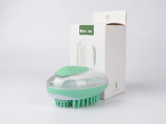 A mint green and clear silicone hair brush with green bristles, shown in front of its white packaging box with a green 'hilstar' label, on a light gray background.