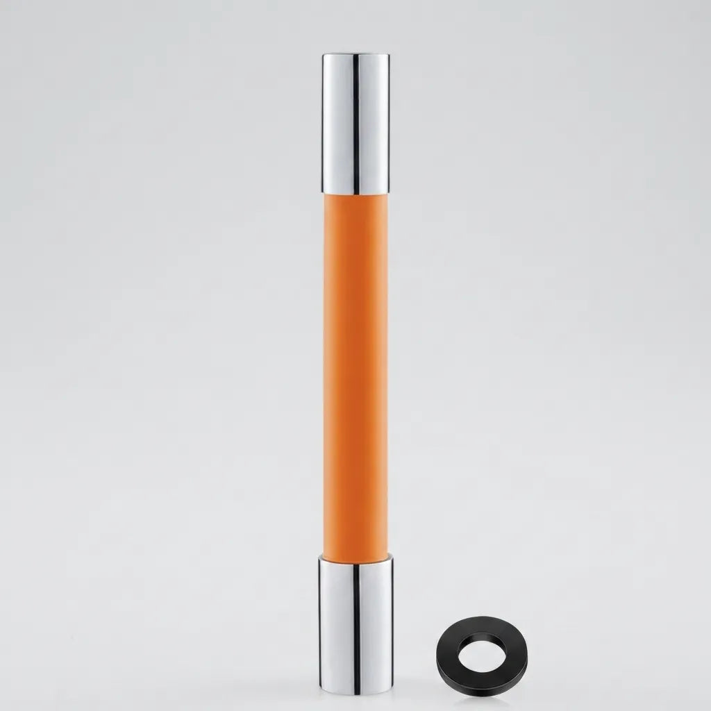 An orange cylindrical cosmetic tube with shiny silver metallic caps, shown standing upright on a light gray background with a small black ring accessory placed beside it.