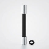 A modern black and silver cylindrical door stopper with a black rubber ring, shown on a clean white background.