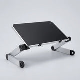 A silver aluminum laptop stand with a black top surface, shown at an angle on a light gray studio background.