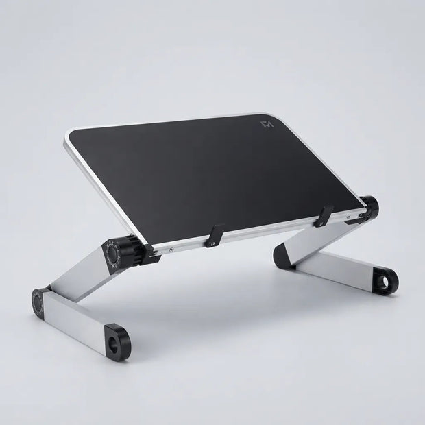 A silver aluminum laptop stand with a black top surface, shown at an angle on a light gray studio background.