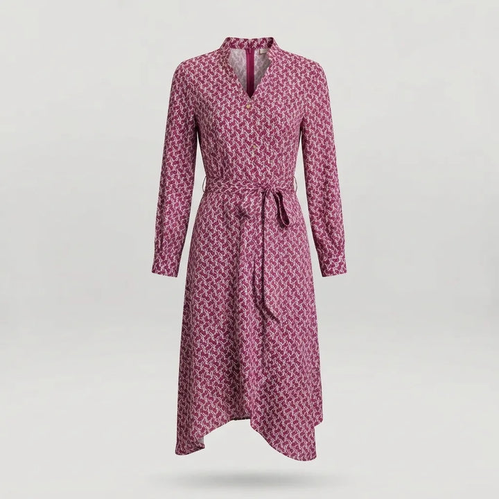 A long-sleeve wrap dress with a geometric pattern in pink and dark red, featuring a tie belt at the waist and a split neckline, shown against a light gray background.