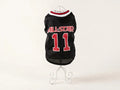 A black pet sports jersey with 'ALL-STAR' and the number '11' in red, displayed on a white wire stand against a plain white background.