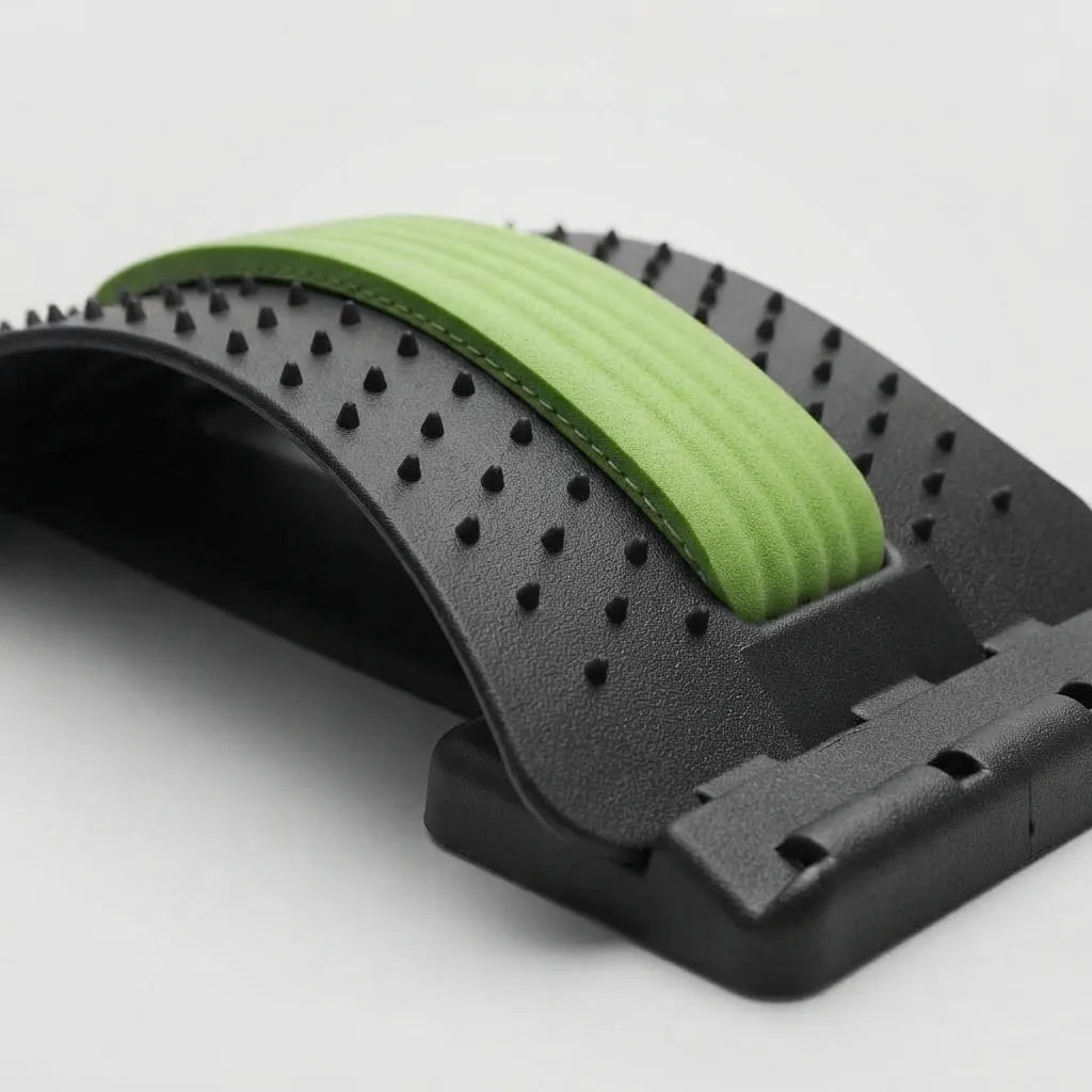 A close-up of a black textured curved strap with small raised nubs and a bright green ribbed inner lining, photographed on a clean light gray background.