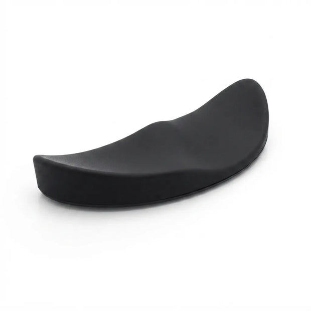 A curved black ergonomic support cushion or pad, photographed on a clean white background.