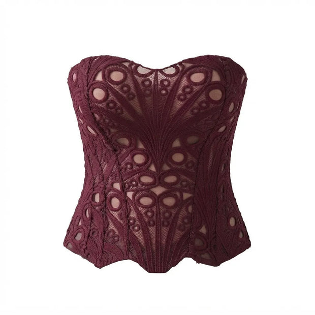 A burgundy lace corset bustier with an intricate floral lace pattern and sheer mesh details, shown against a plain white background.