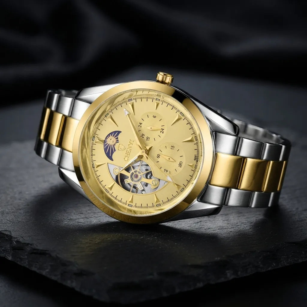 A luxury two-tone wristwatch with a gold and silver stainless steel bracelet, featuring a gold-tone dial with a moon phase indicator and skeletonized details, resting on a dark slate surface.