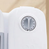 Close-up of a white plastic timer dial with a circular black-and-white countdown scale, set against a warm beige background.