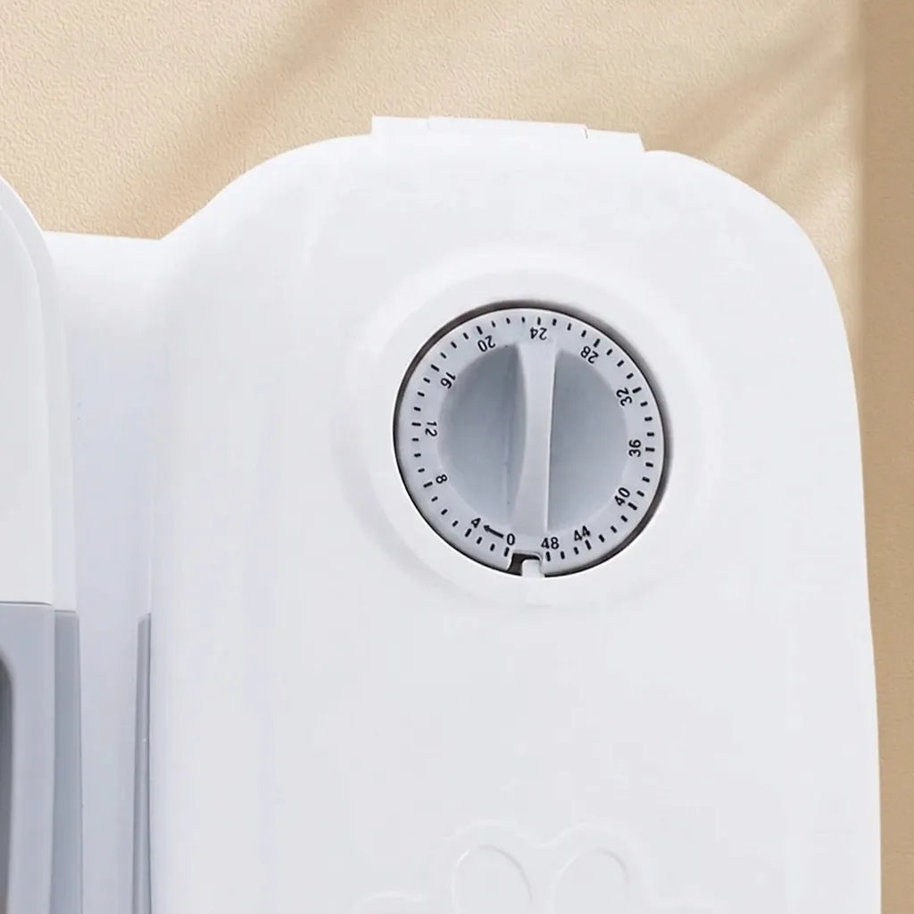 Close-up of a white plastic timer dial with a circular black-and-white countdown scale, set against a warm beige background.
