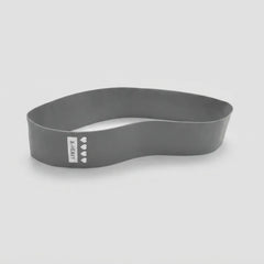 A dark gray silicone headband with a white vertical label that reads 'X-DENY' and features four small white heart icons, shown on a light gray background.