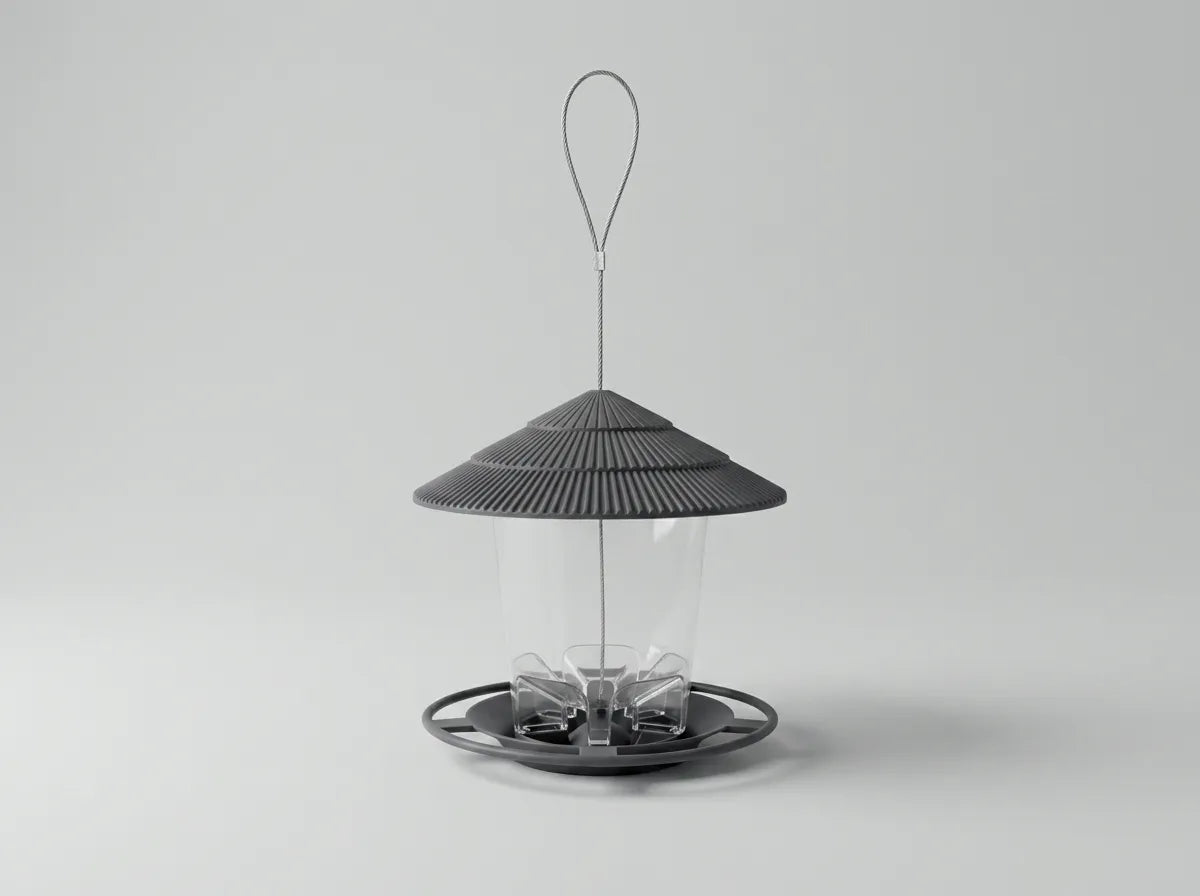 A modern bird feeder with a dark gray ribbed conical roof, a clear cylindrical body, and a circular base with a hanging loop, shown on a light gray background.