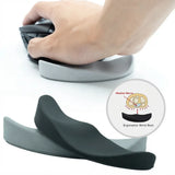 An ergonomic wrist rest shown in two colors, dark gray and light gray, with a hand using one on a desk and a circular inset diagram explaining wrist support.