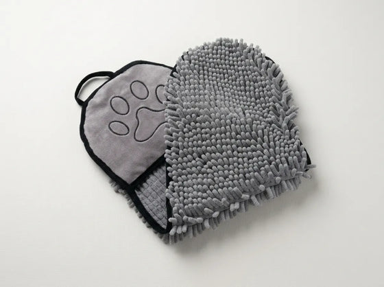 A gray pet microfiber washcloth with a textured chenille side and a soft fabric side featuring an embroidered paw print, displayed on a clean white background.