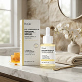 Hoygi Peptide Propolis Renewal Serum shown with its product box and dropper bottle on a marble countertop, styled with a honeycomb, folded towel, flowers, and a mirror in a bright bathroom setting.