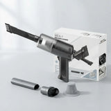 A handheld cordless vacuum cleaner in dark gray and black, shown with its white retail box and several included attachments on a clean light gray studio background. The box reads 'NO.