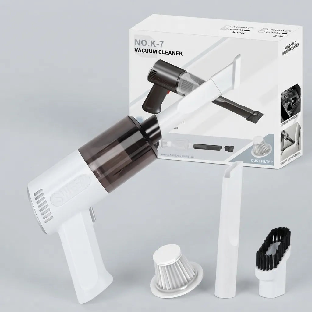 White handheld vacuum cleaner with a dark transparent dust bin, shown with its retail box and three accessories on a light gray background.