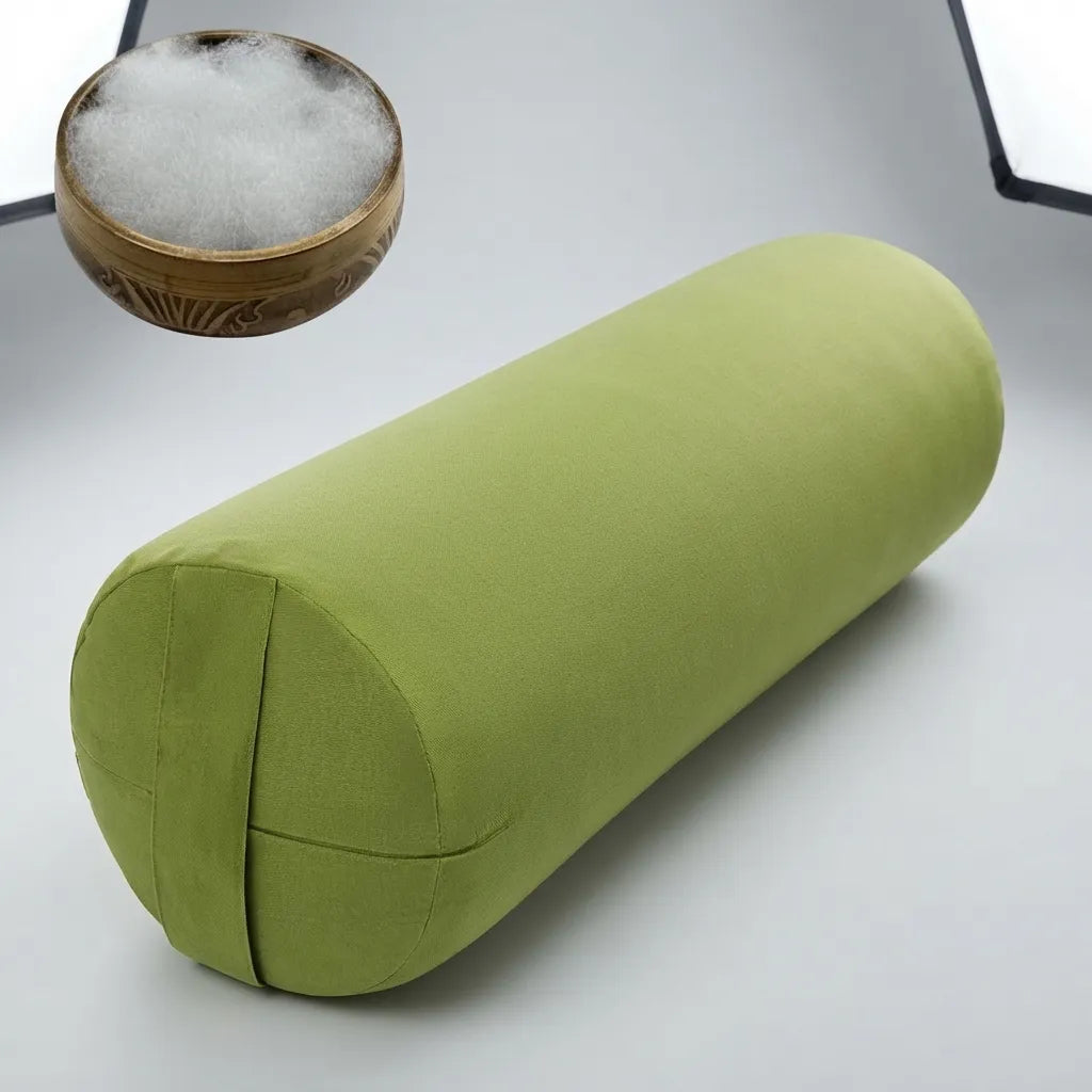 An olive green cylindrical bolster pillow shown on a light gray studio background, with a small inset of white filling material in a wooden bowl.