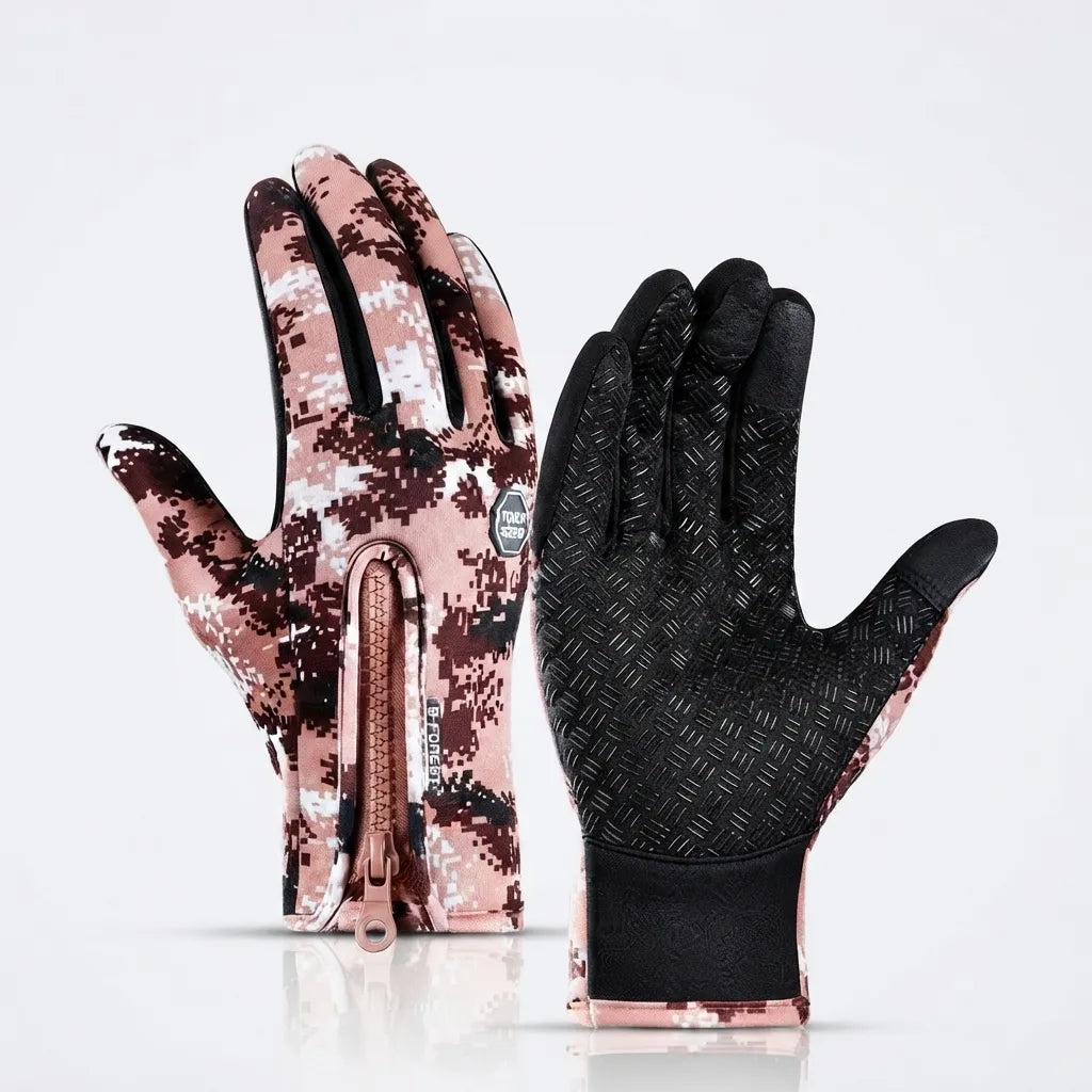 A pair of winter gloves shown front and back on a clean white background. One glove displays a pink, brown, and white digital camouflage pattern with a zipper, while the other shows a black textured palm with matching camouflage edges.