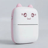 A compact, cute cat-shaped portable device, likely a power bank or mini printer, featuring a white body with a pink side panel, pink ears, and a winking cartoon face on the front.
