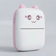 A compact, cute cat-shaped portable device, likely a power bank or mini printer, featuring a white body with a pink side panel, pink ears, and a winking cartoon face on the front.