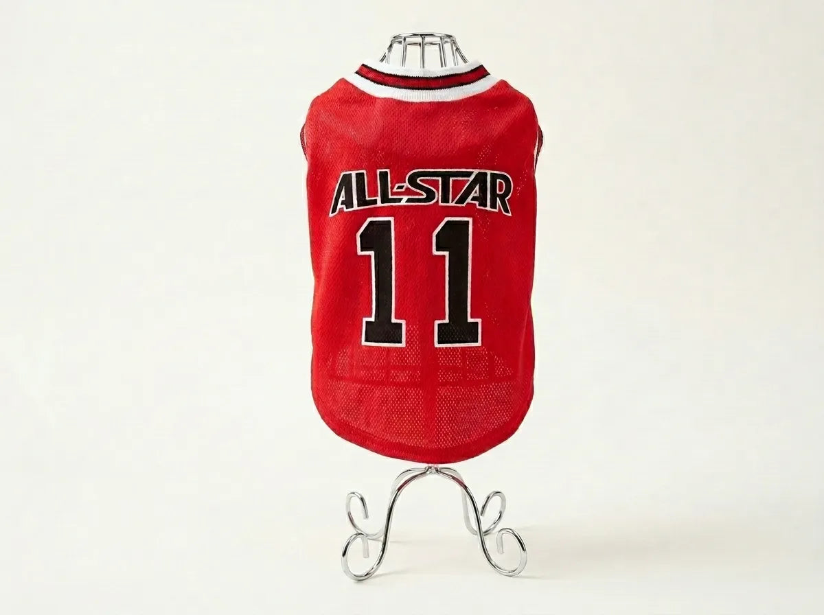 A red mesh pet jersey displayed on a small metal stand against a plain light background. The jersey has a white and red collar and features the text 'ALL-STAR' and the number '11' in black with white outlines on the back.