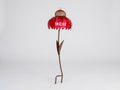 A metal flower garden stake sculpture with a vibrant red petal-shaped top, a brown mesh center, and a long brown stem with leaves, standing on a white studio background.