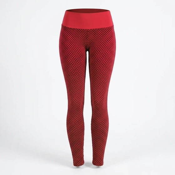 Red high-waisted leggings with a textured honeycomb pattern, shown on a white studio background.