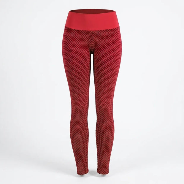 Red high-waisted leggings with a textured honeycomb pattern, shown on a white studio background.