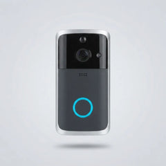 A modern smart video doorbell with a black and dark gray face, silver metallic edges, a central camera lens, and a glowing blue circular indicator light, shown floating against a light gray background.