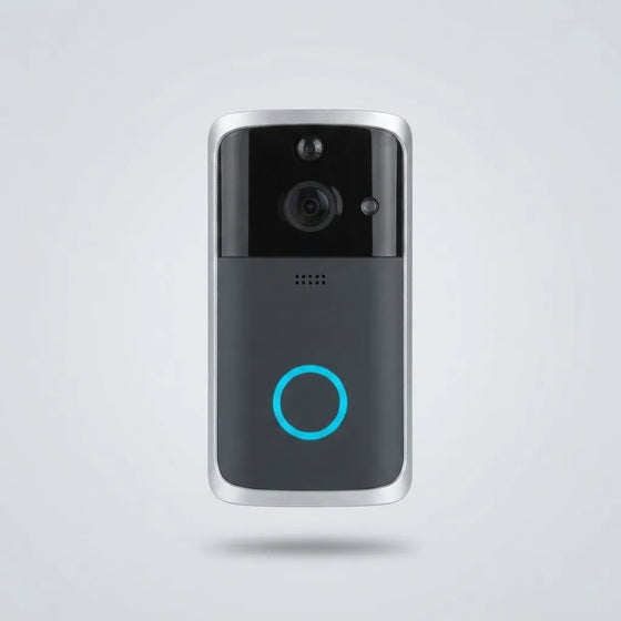 A modern smart video doorbell with a black and dark gray face, silver metallic edges, a central camera lens, and a glowing blue circular indicator light, shown floating against a light gray background.