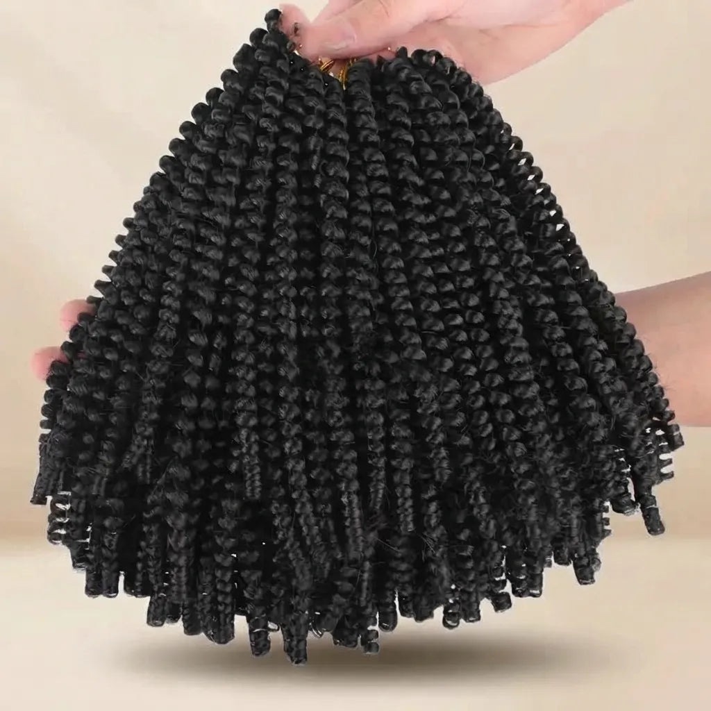 Black curly cornrow hair extensions held up by hands against a plain beige background.