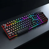 A full-sized mechanical gaming keyboard with RGB rainbow backlighting, resting on a dark wooden desk.