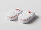 Two white pet training potty bags with pink accents and paw print embossing, shown on a light gray background.