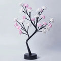 Decorative tree with pink and white flowers on a light gray background