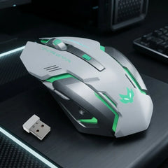 A silver and black gaming mouse with green LED accents and a matching USB receiver, displayed on a dark desk surface.